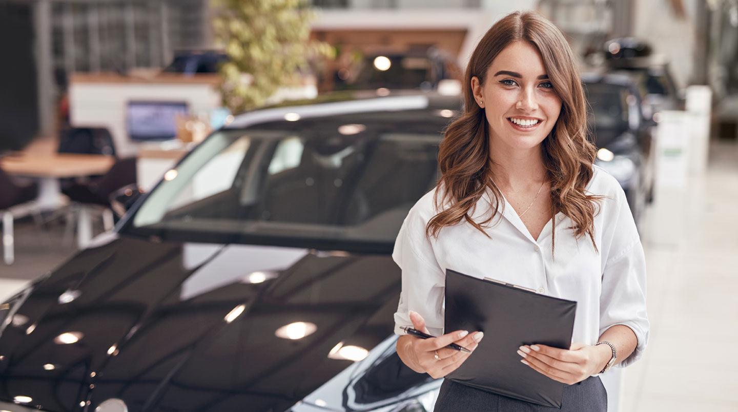 Des mains tiennent des clés de voiture au-dessus de documents administratifs étalés sur une table de cuisine, tasse de café visible en arrière-plan
